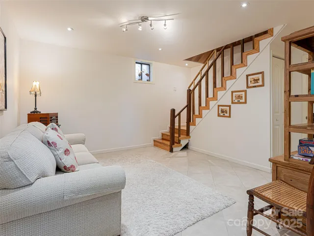 a living room with furniture and stairs