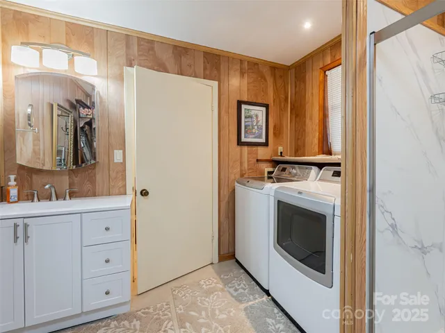 a view of cabinets a sink and a refrigerator in a room