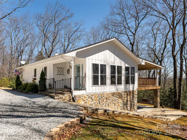 a wooden bench sitting in front of a house