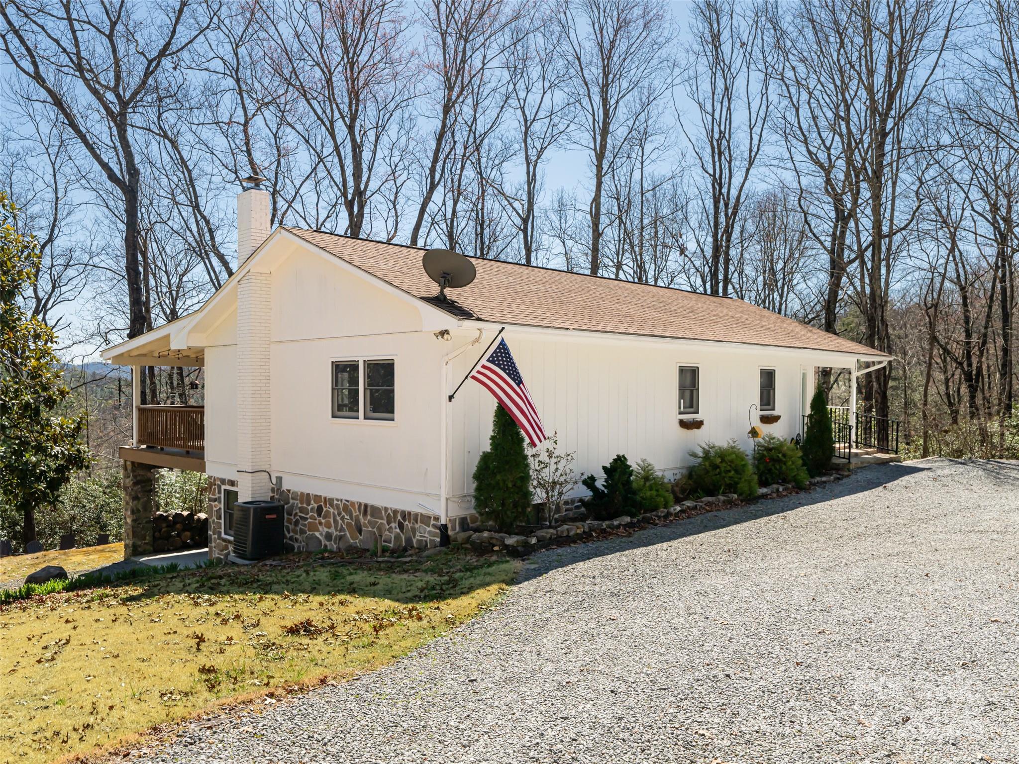 75 Deep Woods Road Mills River, NC 28759 - Photo 5 of 48 a view of a white house with a yard covered in snow