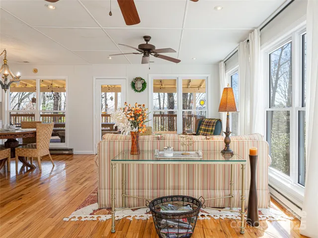 a dining room with furniture a chandelier and wooden floor