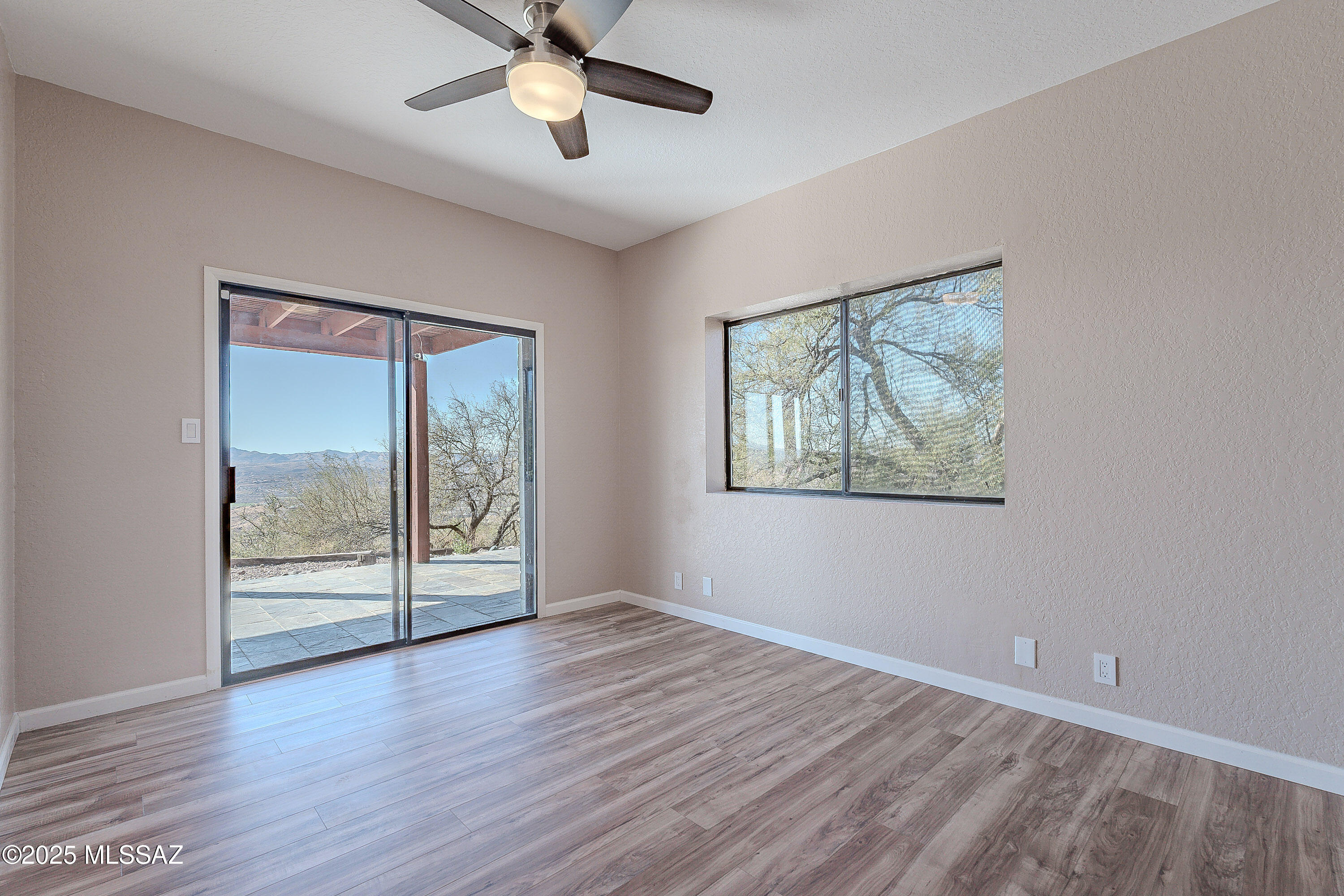 467 Camino Osito Rio Rico, AZ 85648 - Photo 35 of 50 a view of an empty room with wooden floor and a window