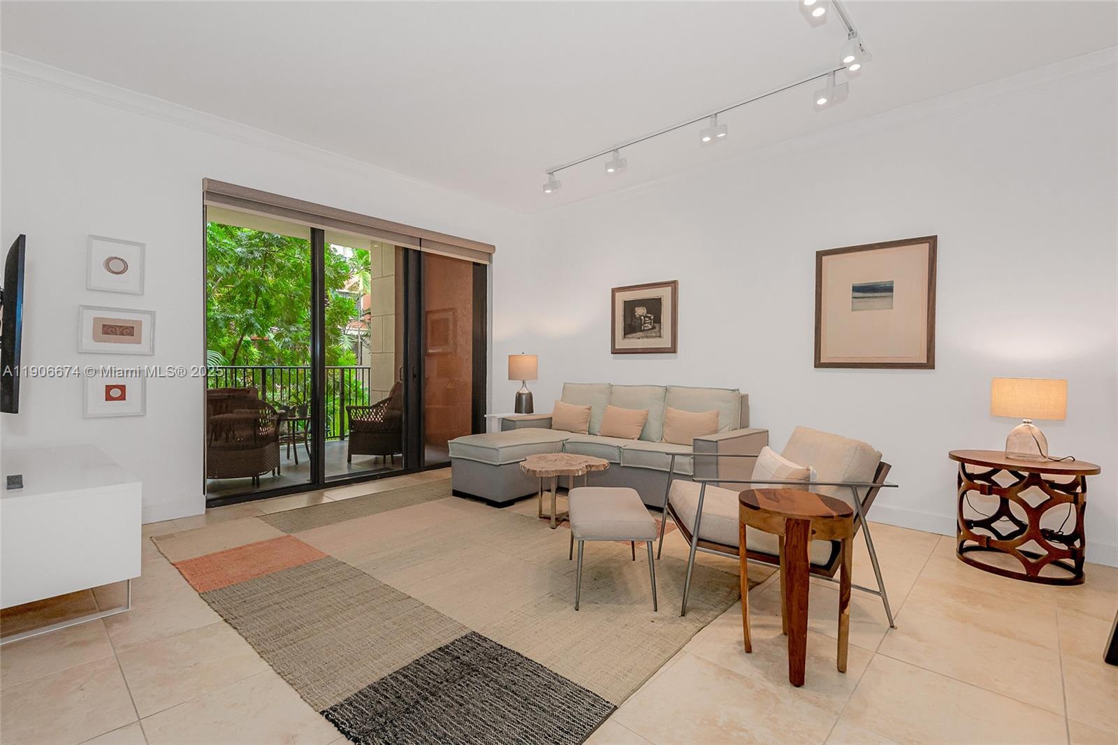 100 Andalusia Avenue, Unit 210 Coral Gables, FL 33134 - Photo 12 of 29 a living room with furniture and a large window