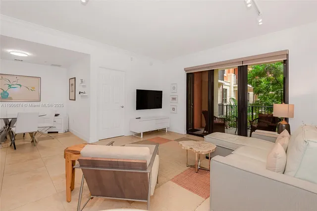 a living room with furniture and large flat screen tv