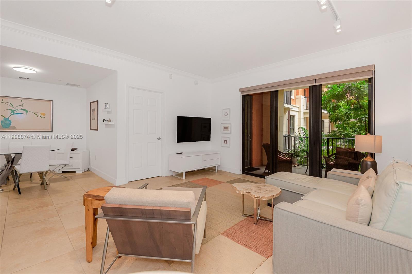 100 Andalusia Avenue, Unit 210 Coral Gables, FL 33134 - Photo 13 of 29 a living room with furniture and large flat screen tv