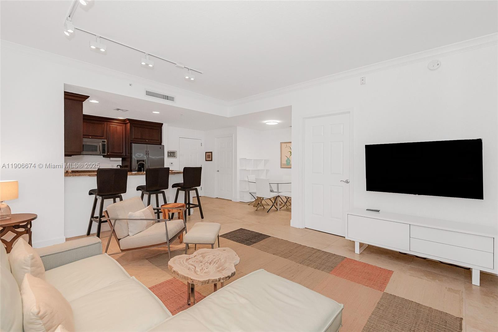 100 Andalusia Avenue, Unit 210 Coral Gables, FL 33134 - Photo 14 of 29 a living room with furniture and a flat screen tv