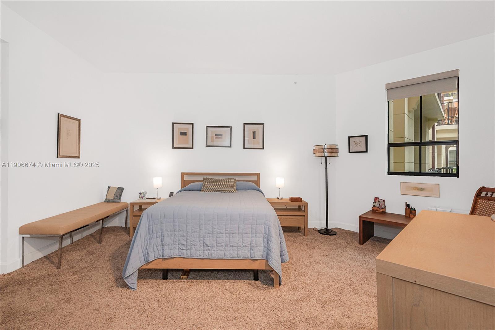 100 Andalusia Avenue, Unit 210 Coral Gables, FL 33134 - Photo 19 of 29 a bedroom with a bed and a lamp