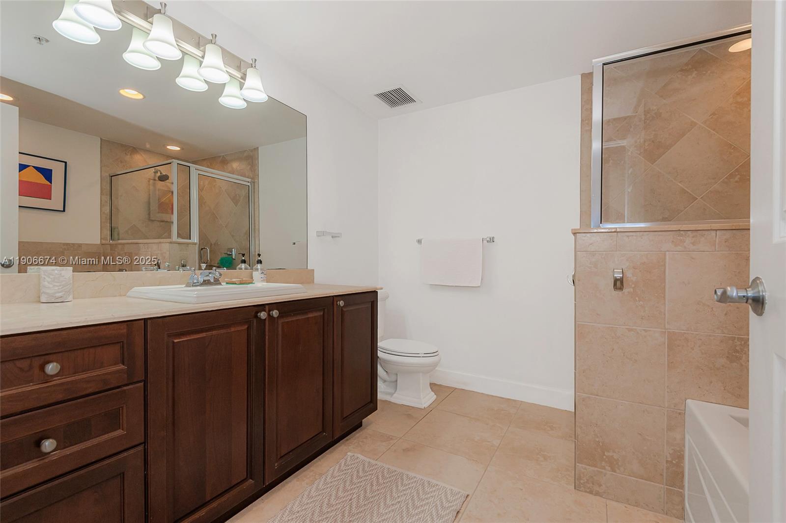 100 Andalusia Avenue, Unit 210 Coral Gables, FL 33134 - Photo 22 of 29 a bathroom with a double vanity sink mirror and toilet
