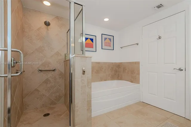 a bathroom with a bathtub and shower