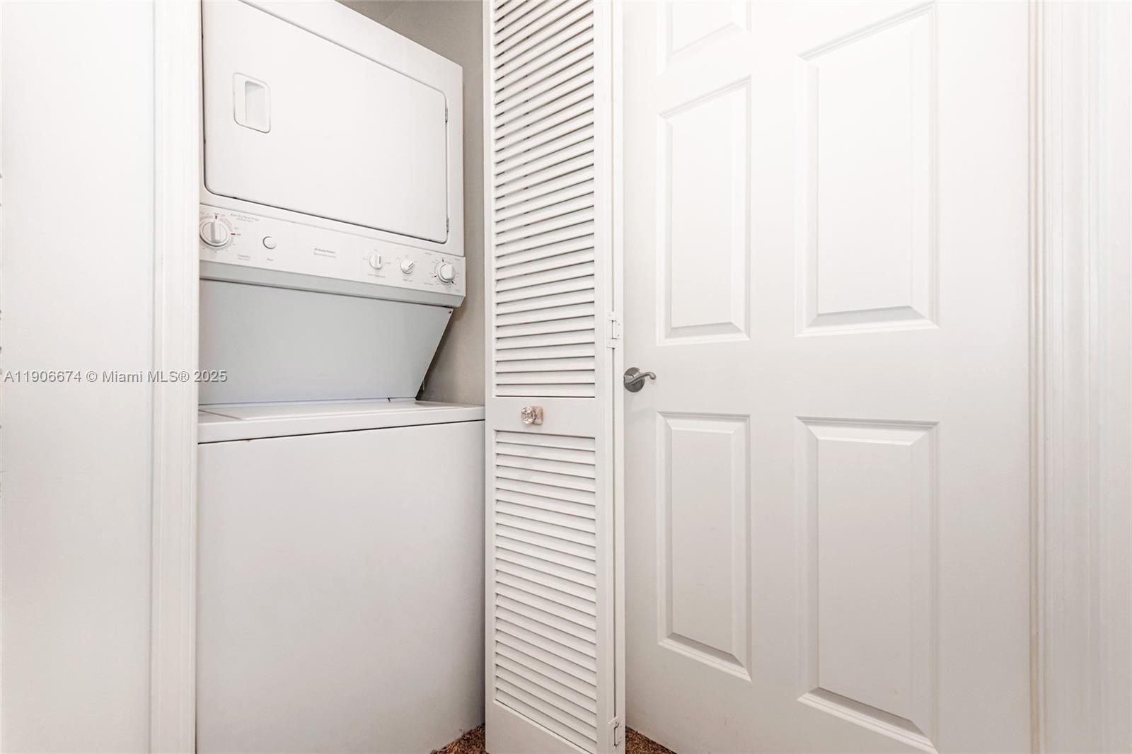 100 Andalusia Avenue, Unit 210 Coral Gables, FL 33134 - Photo 24 of 29 a utility room with dryer and washer