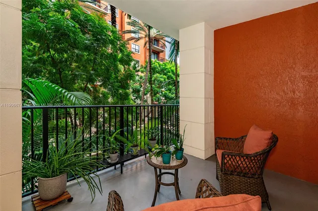 a balcony with chairs and potted plants