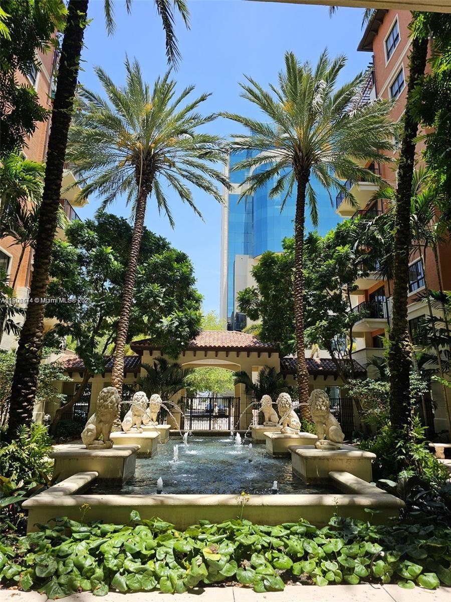 100 Andalusia Avenue, Unit 210 Coral Gables, FL 33134 - Photo 28 of 29 a view of a house with a yard and palm trees