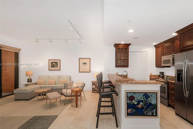 a living room with furniture a refrigerator and a stove