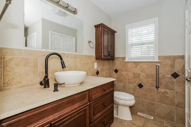 a bathroom with a sink toilet a mirror and shower