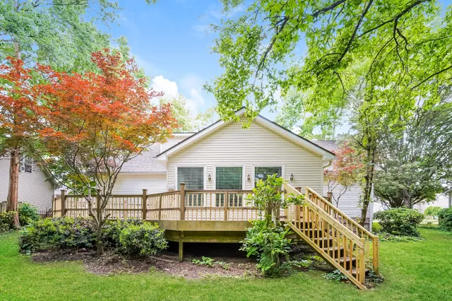 a view of a house with a yard and potted plants
