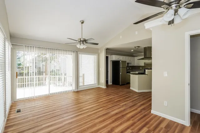 a view of a kitchen with a sink and wooden floor