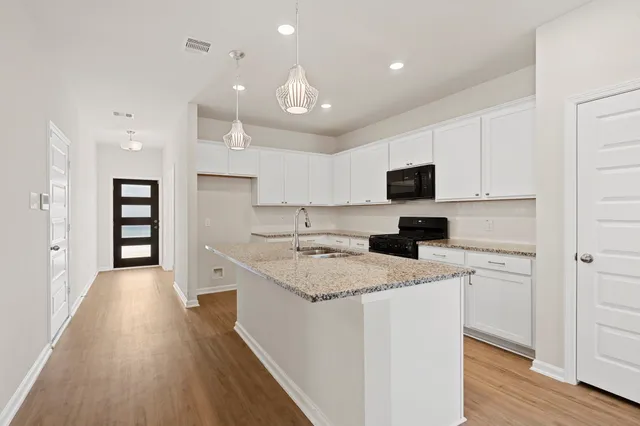 a kitchen with a stove a sink and a refrigerator