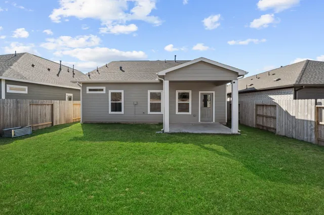 a backyard of a house with table and chairs