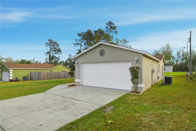 a view of a house with a yard and garage