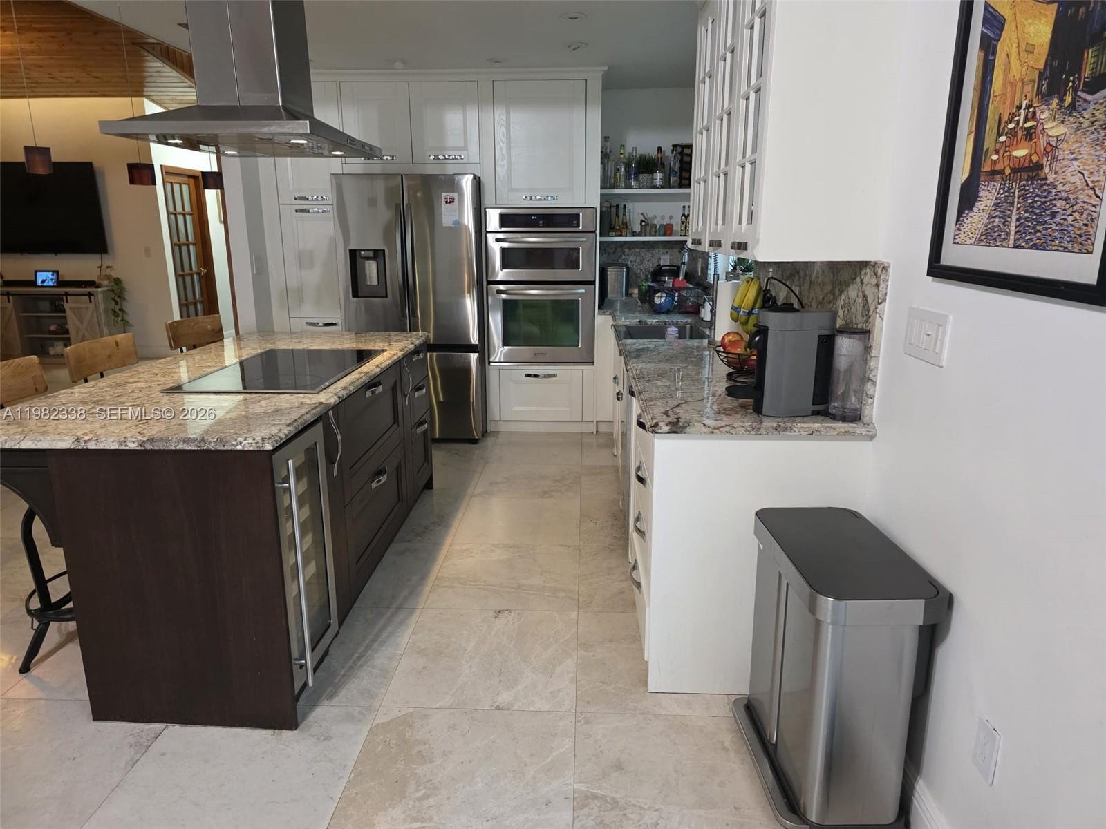 14530 Southwest 110th Street Miami, FL 33186 - Photo 11 of 45 a kitchen with stainless steel appliances kitchen island granite countertop a refrigerator and a stove top oven
