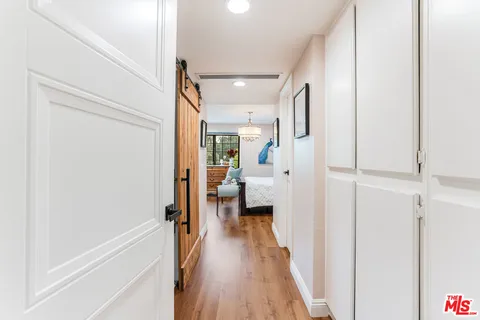 a view of a hallway with wooden floor and staircase