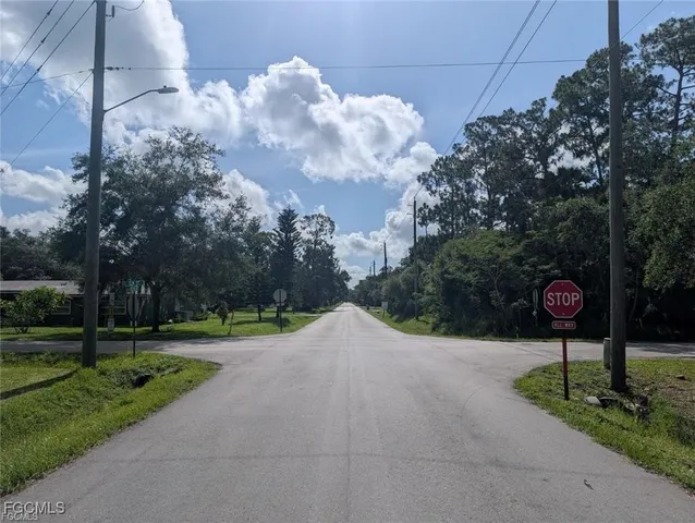 a street sign on a sidewalk next to a road