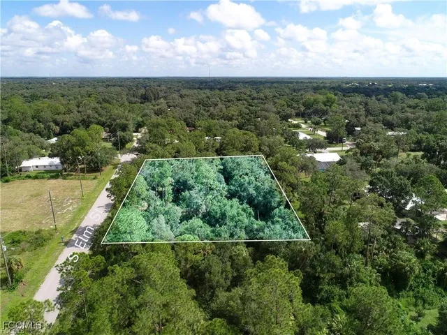 an aerial view of residential houses with outdoor space and lake view