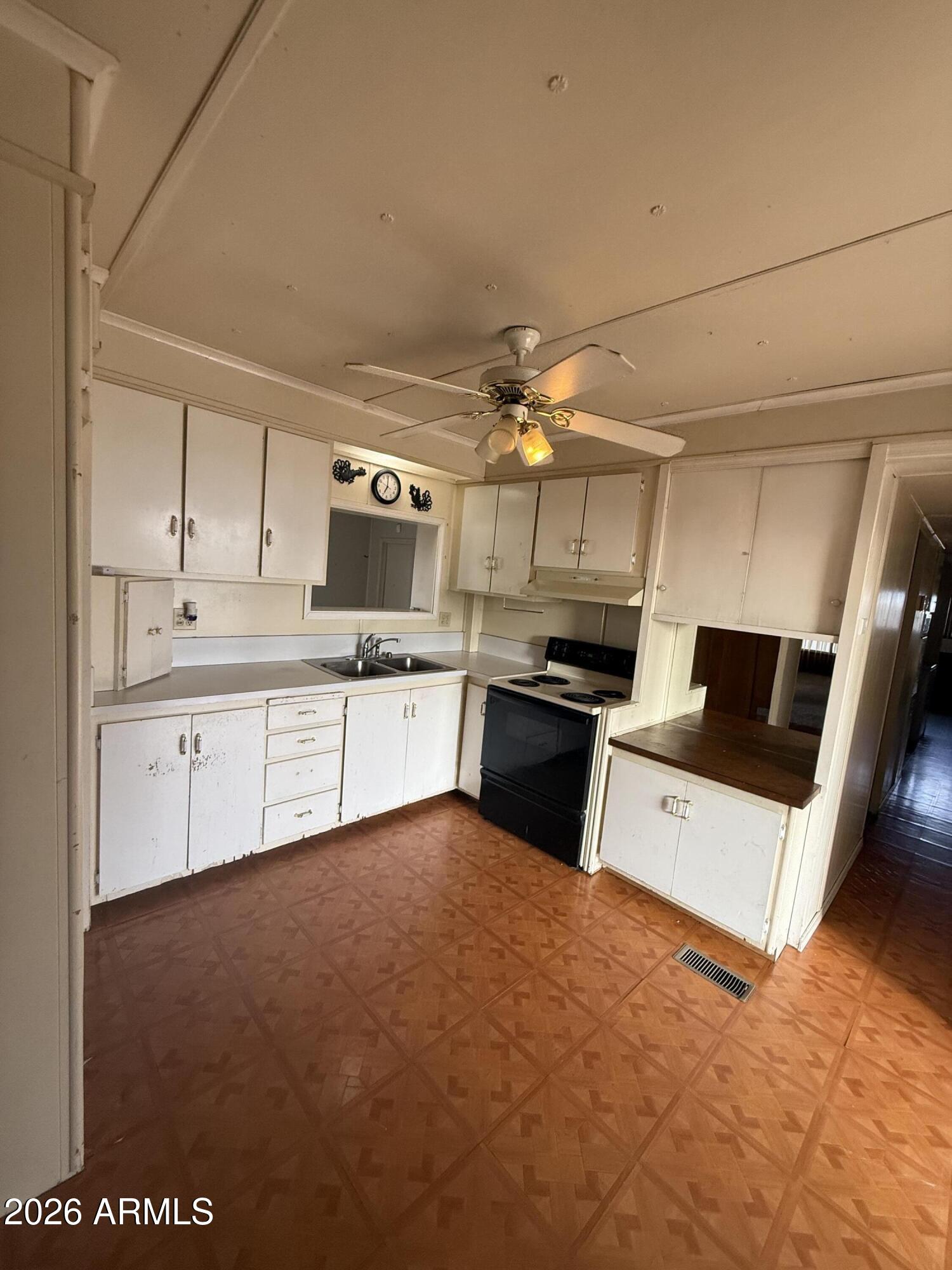 234 South 75th Way Mesa, AZ 85208 - Photo 12 of 18 a large white kitchen with a sink stainless steel appliances and cabinets