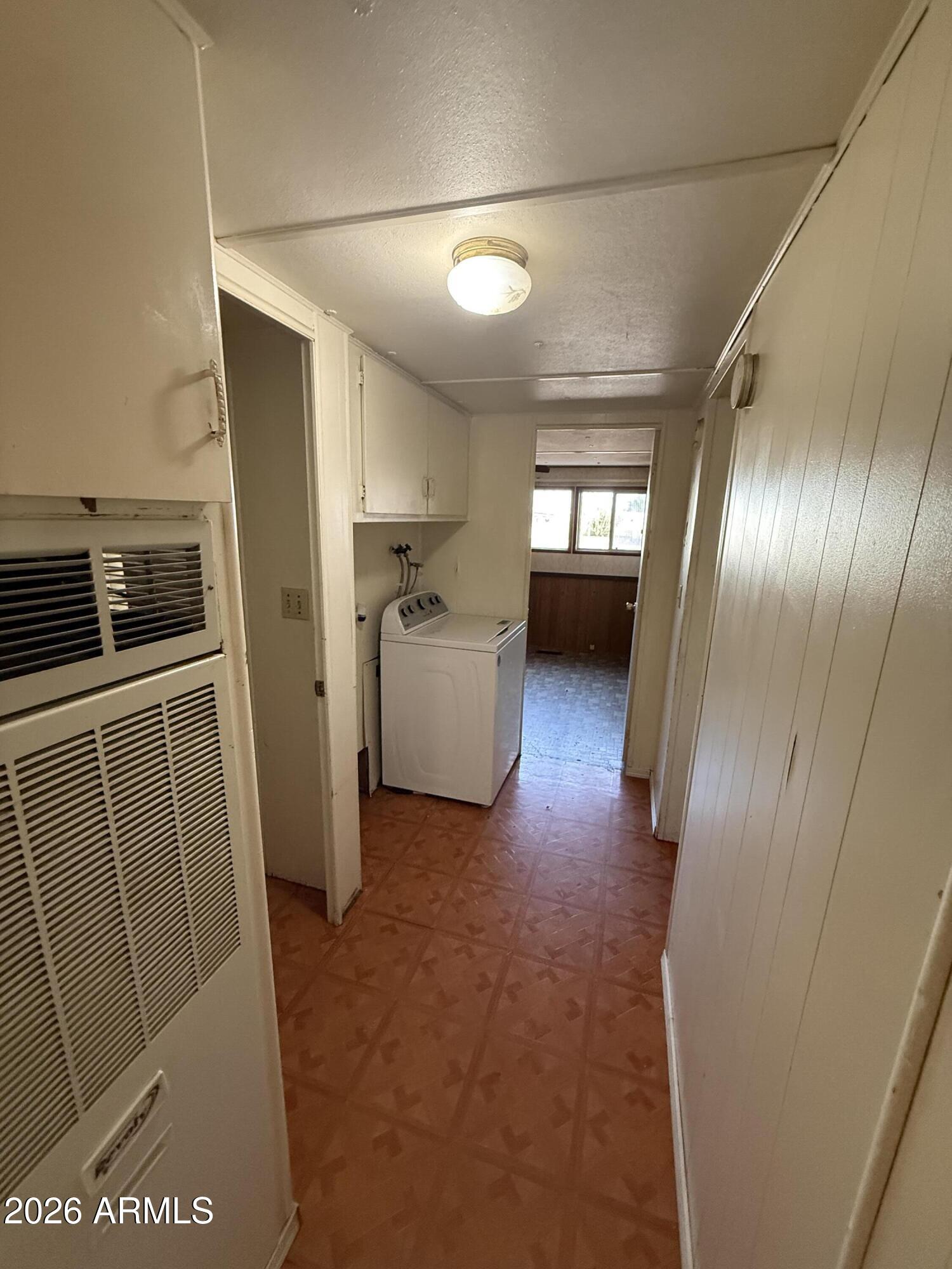 234 South 75th Way Mesa, AZ 85208 - Photo 14 of 18 a view of a hallway with furniture and a refrigerator