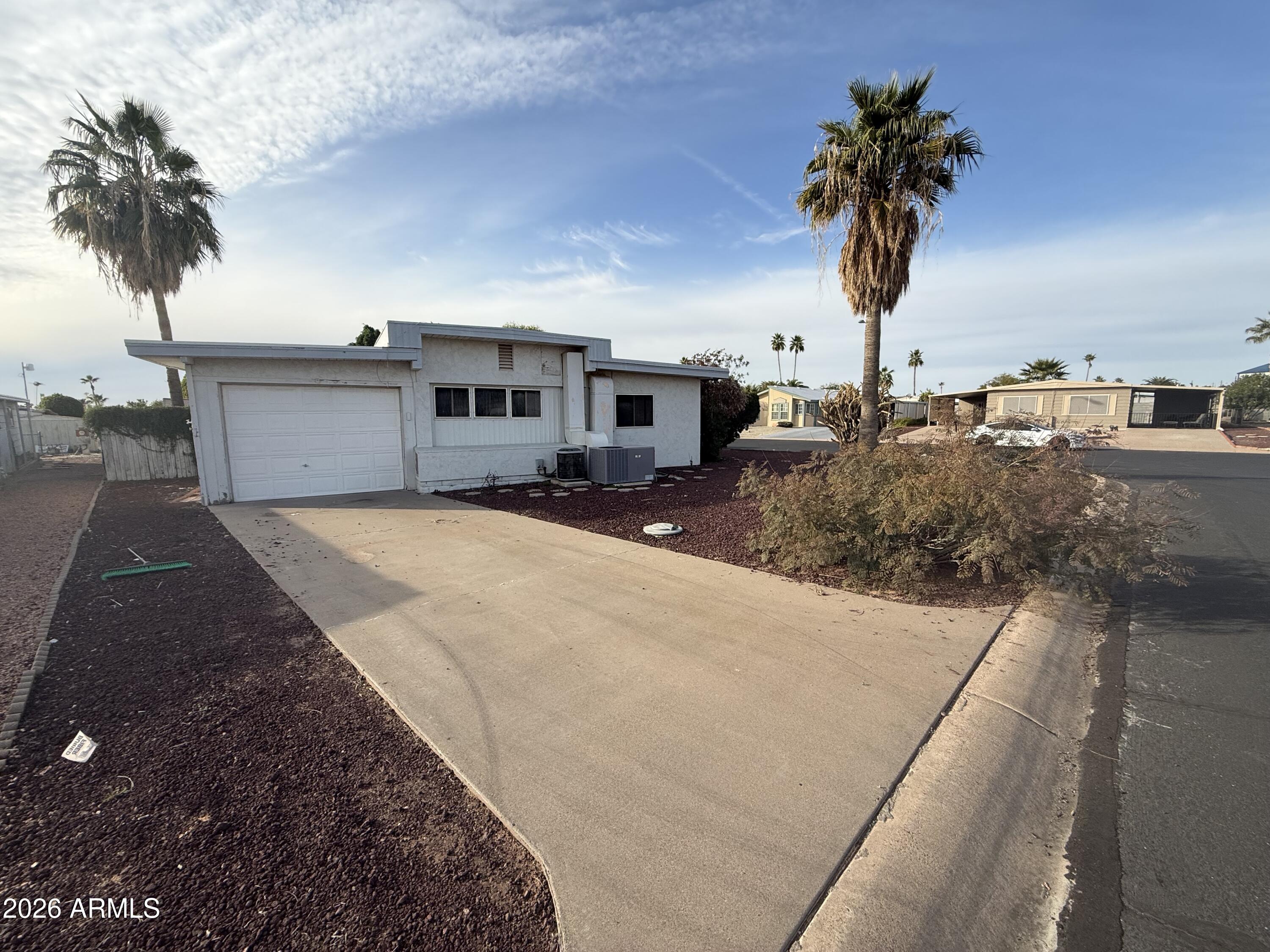 234 South 75th Way Mesa, AZ 85208 - Photo 2 of 18 a front view of a house with a yard and palm trees