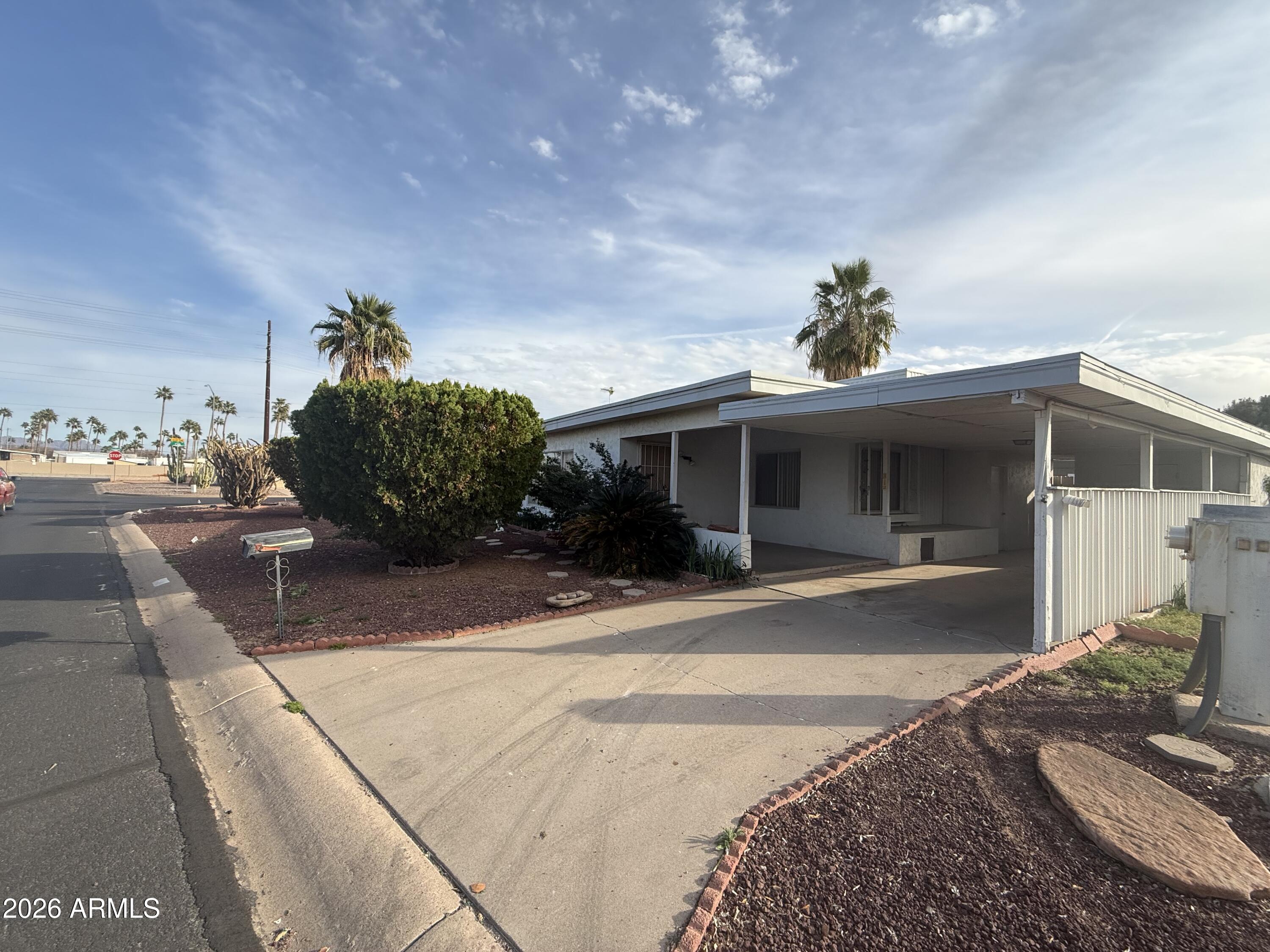 234 South 75th Way Mesa, AZ 85208 - Photo 4 of 18 a front view of a house with a yard and potted plants
