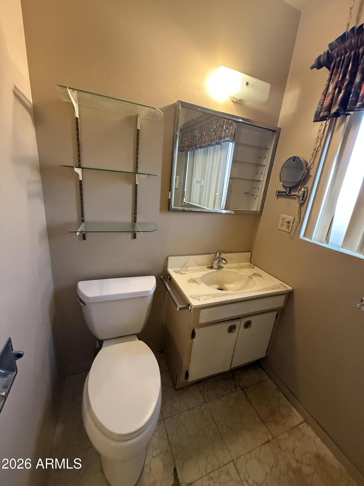 234 South 75th Way Mesa, AZ 85208 - Photo 9 of 18 a bathroom with a toilet and a sink