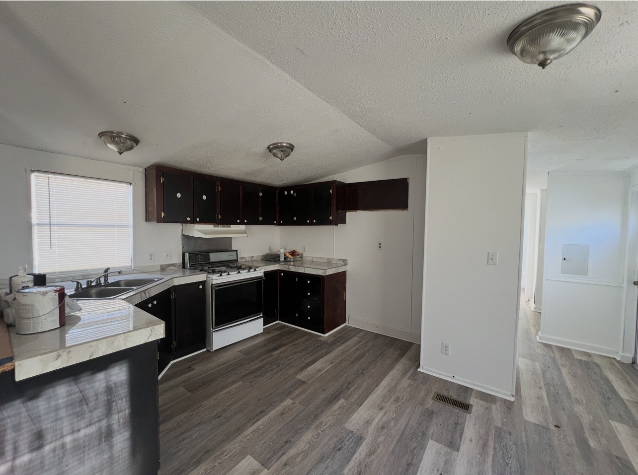 1511-4 Jones Street, Unit 4 Rosenberg, TX 77471 - Photo 5 of 11 a large kitchen with a wooden floor and cabinets