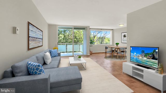 a living room with furniture large window and flat screen tv