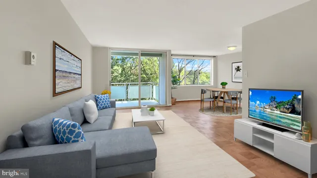 a living room with furniture large window and flat screen tv