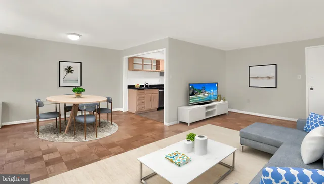 a living room with furniture and a dining table