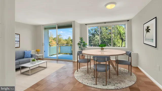a living room with furniture a table and a large window