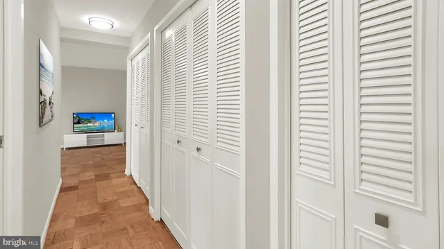 a view of a hallway with wooden floor and staircase