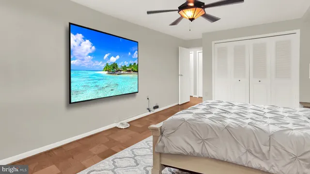 a bedroom with a large bed and a painting on the wall