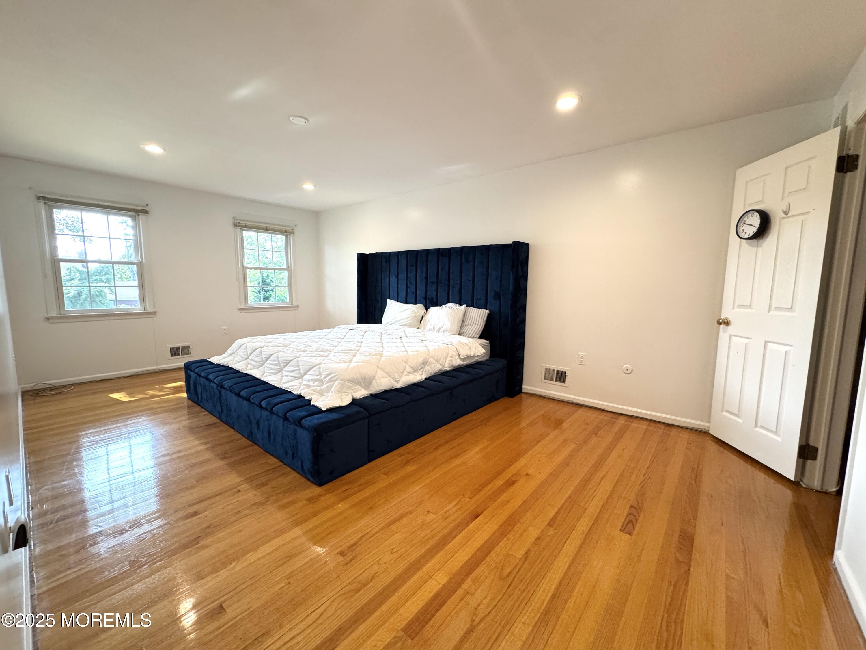 28 Ridge Road West Long Branch, NJ 07764 - Photo 6 of 8 a bedroom with a bed and wooden floor