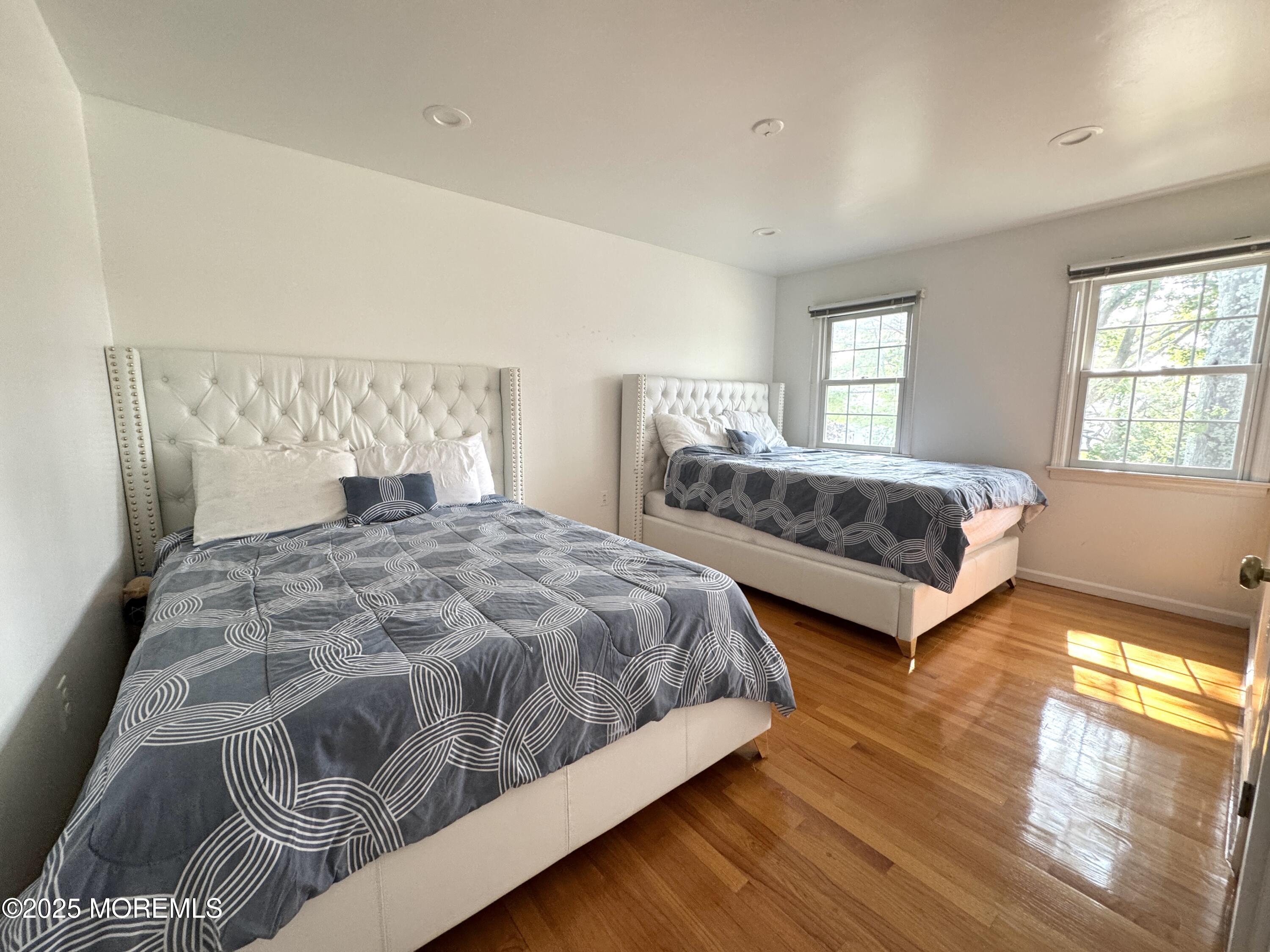 28 Ridge Road West Long Branch, NJ 07764 - Photo 7 of 8 a spacious bedroom with a bed and wooden floor