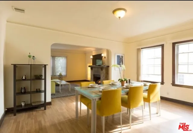 a living room with dining table and wooden floor