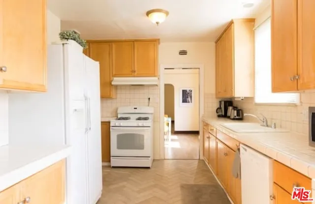 a kitchen with a refrigerator a sink and a stove