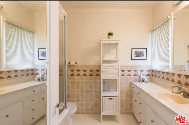 a bathroom with a sink double vanity and a shower
