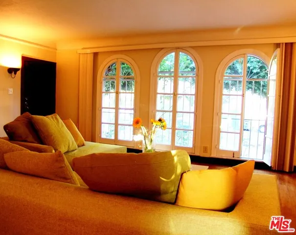 a bedroom with a bed and glass windows