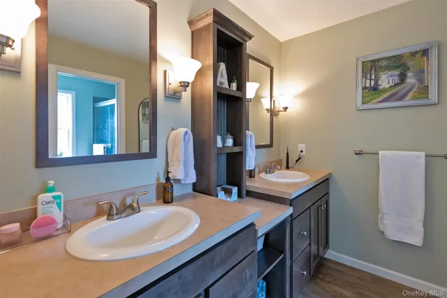 a bathroom with a sink vanity and a mirror