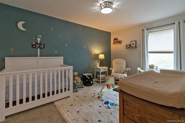 a bedroom with furniture and a window