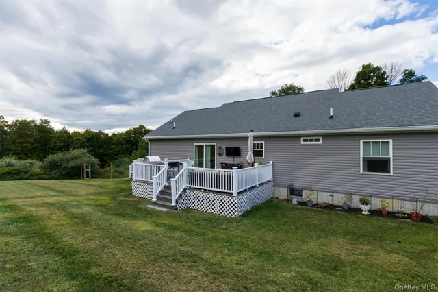 a backyard of a house with table and chairs