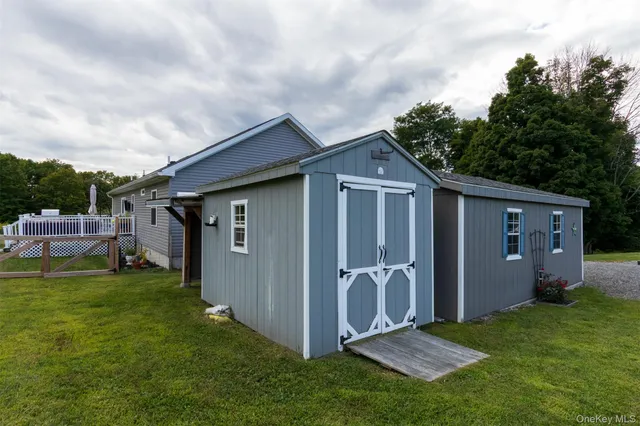 a view of balcony with wooden floor and outdoor seating