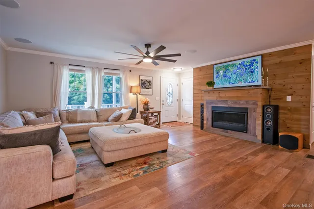 a living room with furniture a fireplace and a large window